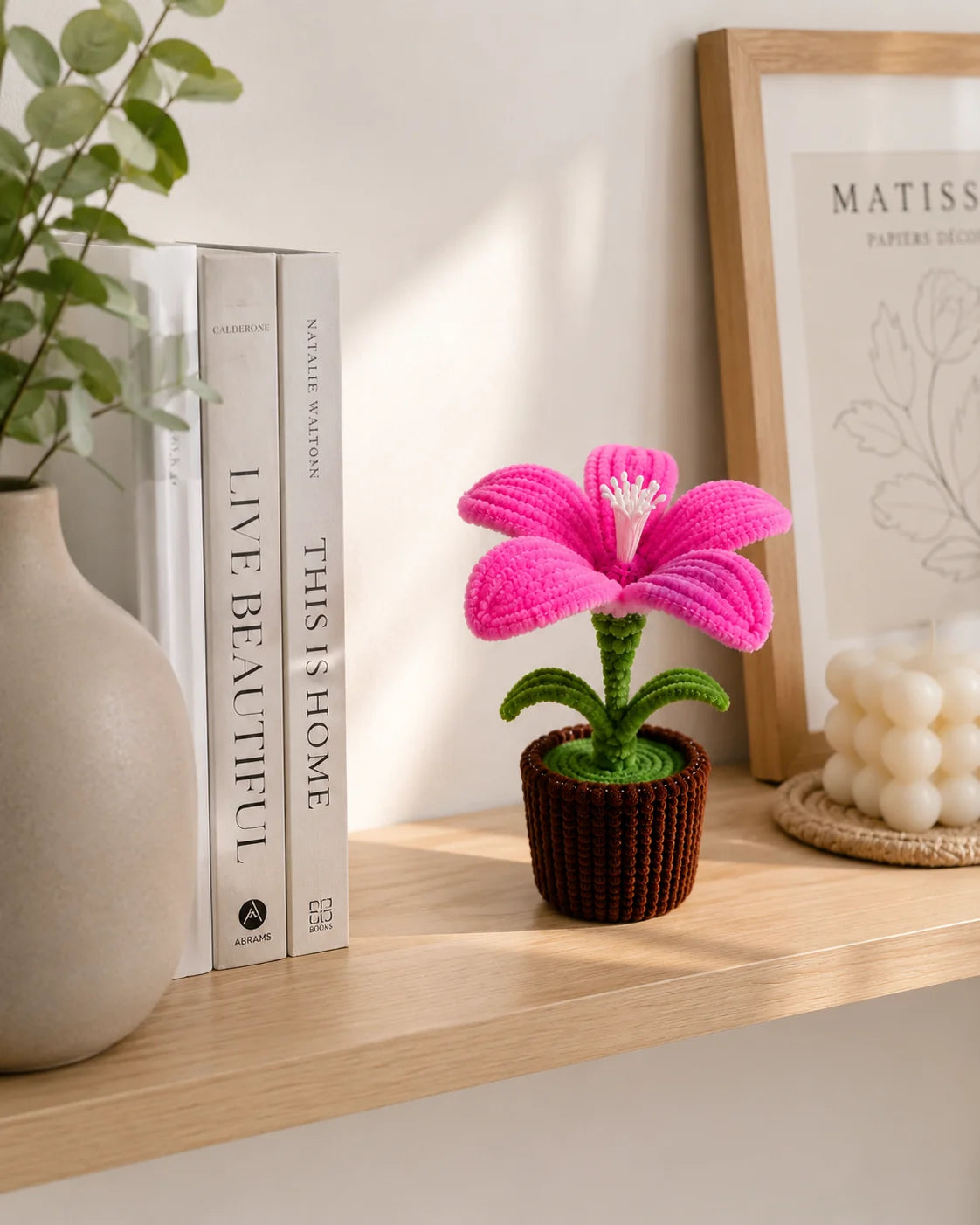 Handmade pink lily pipe cleaner potted plant on a shelf with books - YouLove
