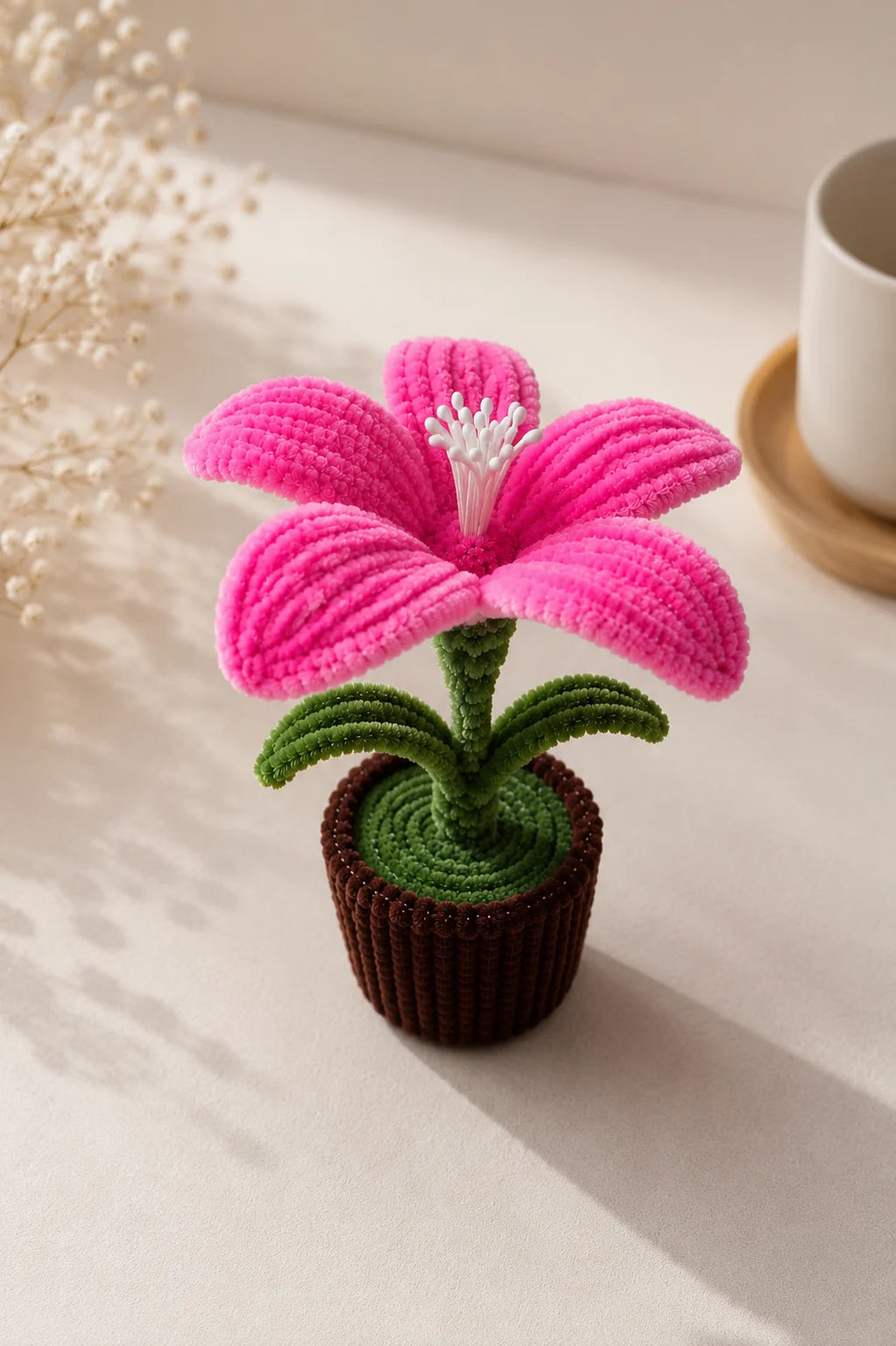 Pink chenille lily flower in a woven brown pot, close-up - YouLove handmade decor