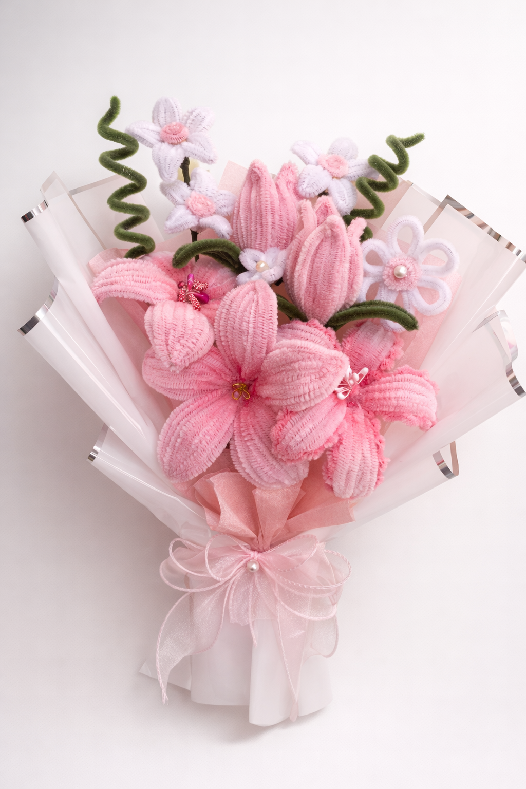 Handmade pink pipe cleaner flower bouquet with lily-style flowers and pastel wrapping, ready-to-gift arrangement.
