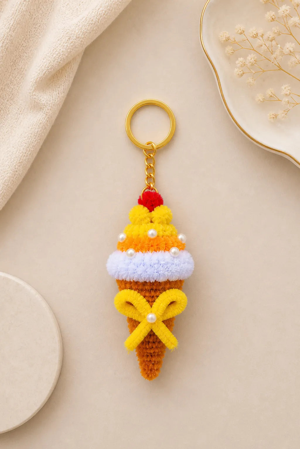 Handmade ice cream cone keychain with colorful layers, cherry top and pearl details made from pipe cleaners aesthetic product photo
