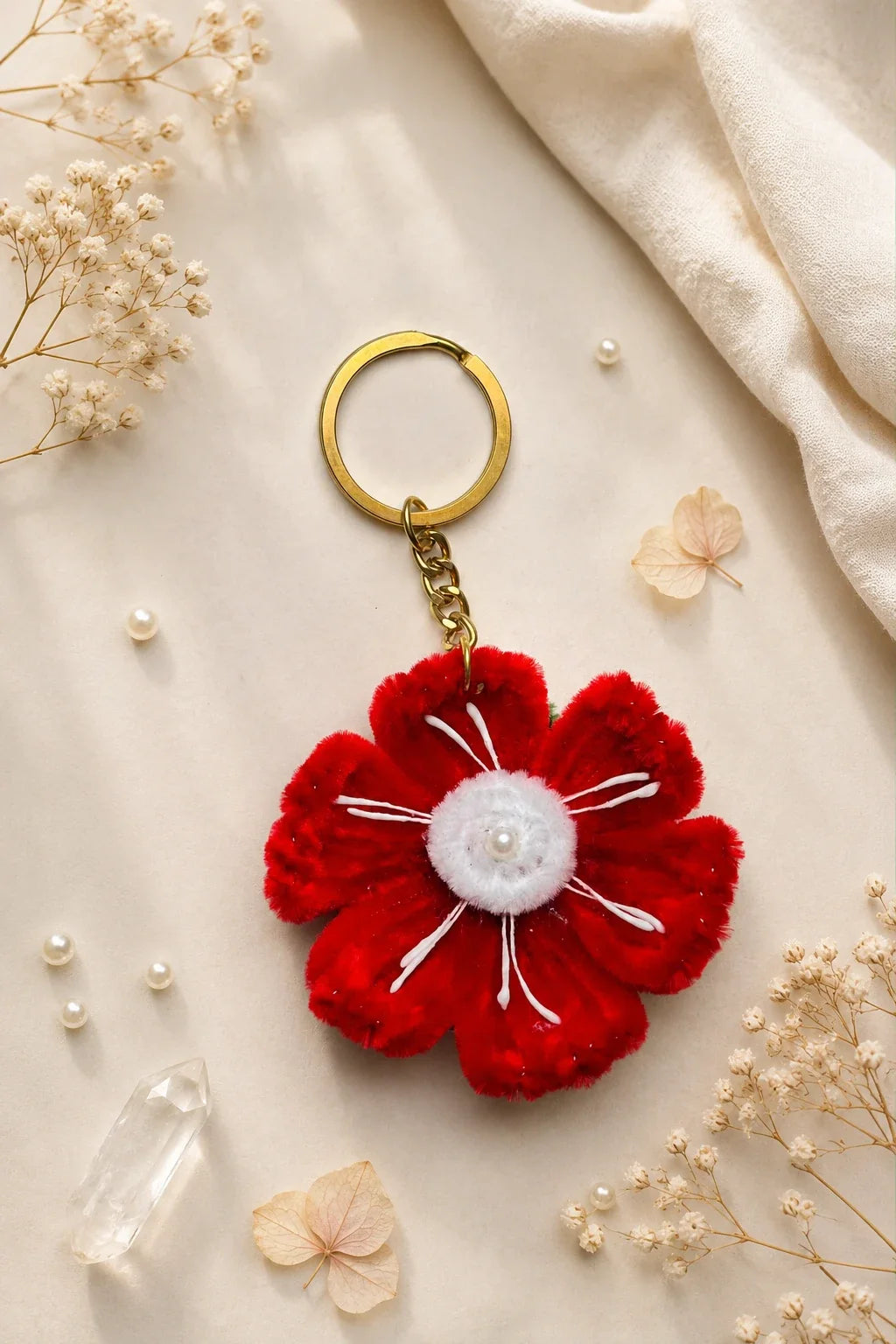 Red poppy pearl keychain close-up - handmade velvet flower with pearl center on gold keyring