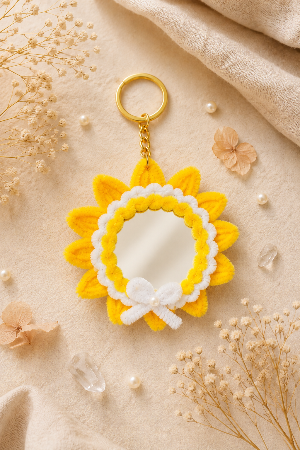 Sunflower dual-face mirror keychain hanging on a canvas tote bag handle